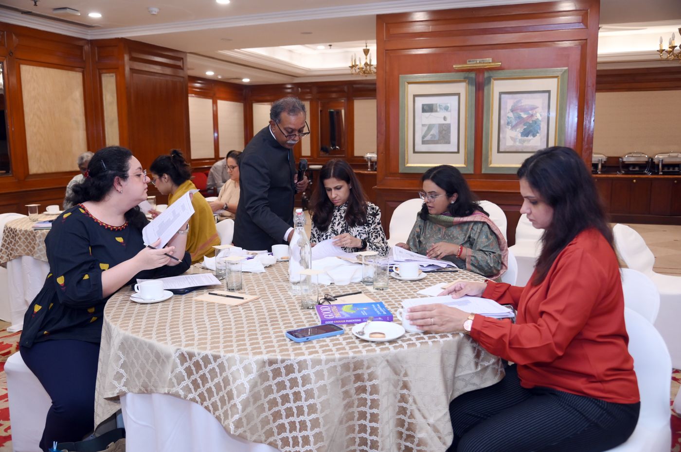 Dr. John Philip Louis going through participants' work at their table